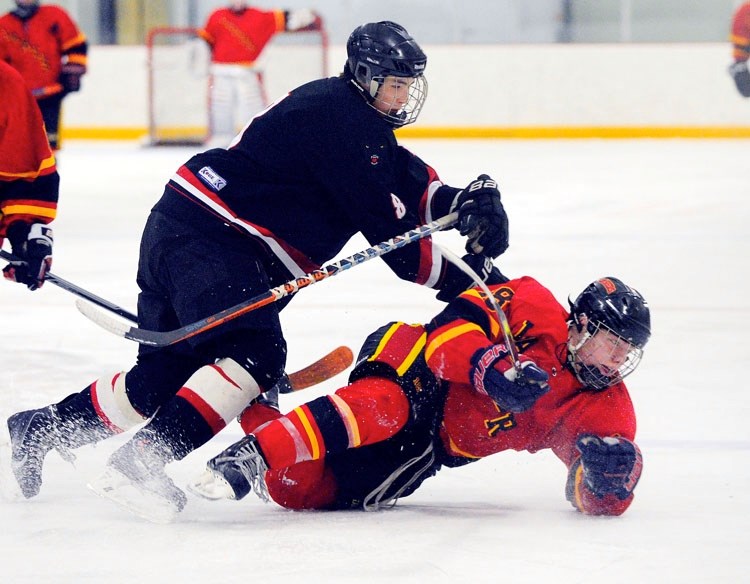 Bow Valley Timberwolves forward Colton Wong drills Sylvan Lake Lakers forward Kyle Cornford in South Central Alberta Midget AA Hockey League playoff play Feb. 19 at Spray