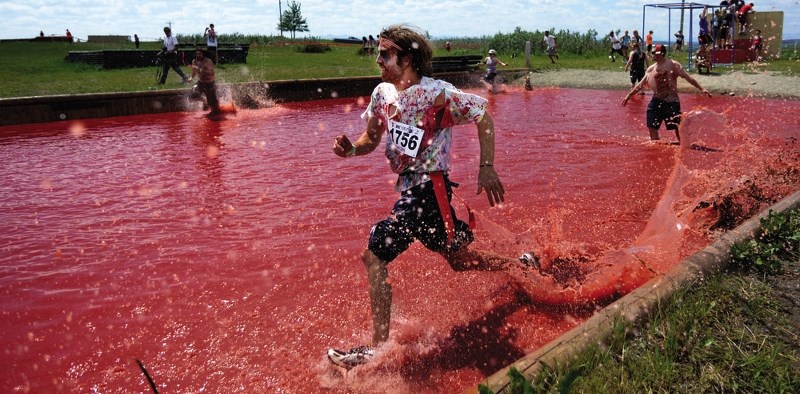 Connor Gray runs through a &#8216;pool of blood&#8217; at last year&#8217;s Zombie Survivor race. Registration for this summer&#8217;s event at the Cochrane Agricultural