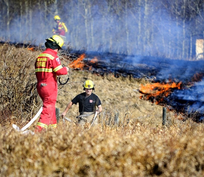 Rocky View County fire crews, including Cochrane Fire Services, battle a grassfire near Bearspaw Road last April. March 1 officially marks the start of wildfire season, and