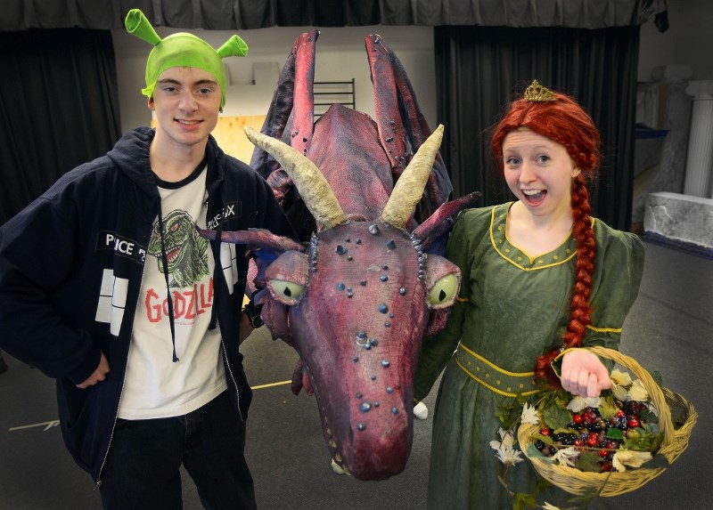 Shrek, played by Fynley Haines, dragon, played by Brynn Anderson, and Fiona, played by Zoe Farrell, prepare for Bow Valley High School&#8217;s performance of Shrek the
