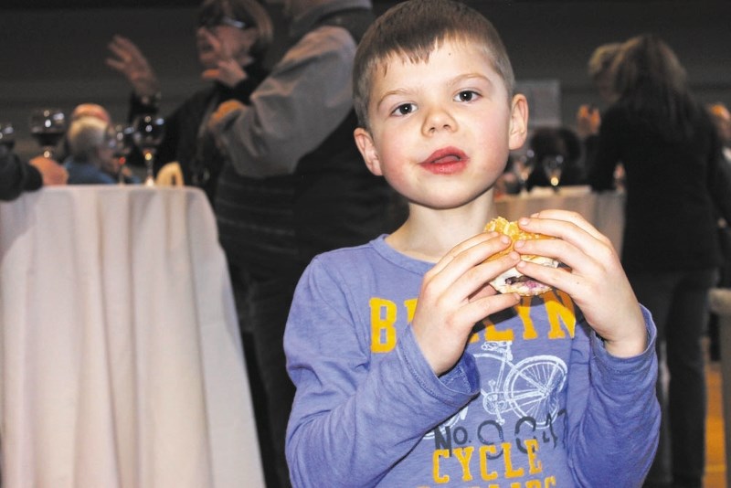 Bragg Creek resident Tristan Parker enjoys a slider at last year&#8217;s Taste of Bragg Creek.