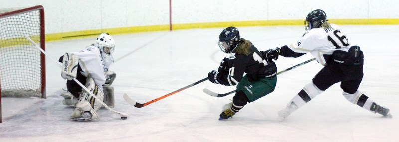 Rocky Mountain Raiders forward Megan Campbell of Cochrane goes hard to the net in Alberta Major Bantam Female Hockey League South Division final play against visiting Calgary 