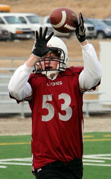 Eric Ferguson goes up for a pass during a Cochrane Midget Lions preseason training-camp session March 23 at Edge School field. The Lions are preparing for the 2015 Calgary