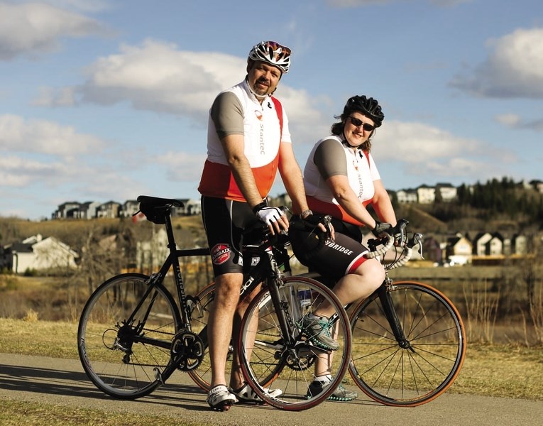 Jeff Simpson, left, and Gerri Fraser of the Stantec Cycling Team pictured in Cochrane prior to their upcoming cycling marathons.