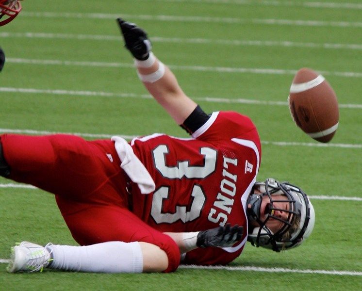 Cochrane Lions running back Sam Cook grimaces after hitting the deck in Calgary Area Midget Football Association preseason jamboree play March 26 in Calgary. The Lions are