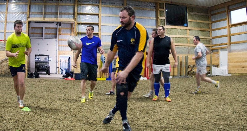 Bow Valley Grizzlies hooker Scott Megraw passes the ball during a training session at a Jumping Pound equestrian centre the team uses.
