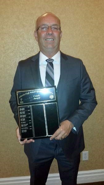 Cochrane High School Cobras football co-head coach and defensive coordinator Bruce O&#8217;Neil displays his Alberta Schools&#8217; Athletic Association Coaching Hall of Fame 