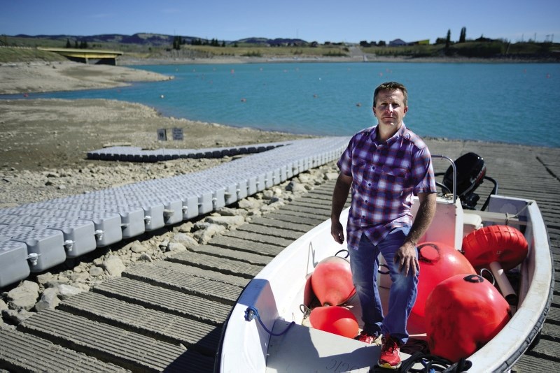 Ghost Lake Recreations owner Mike Weinert and manager of the provincial campground shows the Cochrane Eagle just how low the water level has gone, and said he expects the