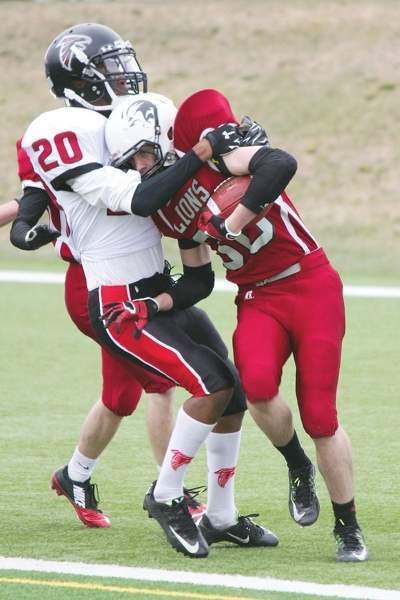 Cochrane Lions kick returner Luke Kruger fights for yards in Calgary Area Midget Football Association playoff play vs. Calgary Falcons on May 13 in Calgary. Falcons won 40-1, 