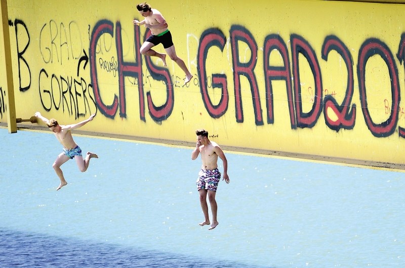 Students jump off the Ghost Lake bridge last year, which has become a yearly tradition for graduates.