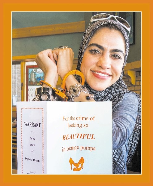 Dijla Al-Rekabi sports orange handcuffs after being served “;warrant”for her arrest.