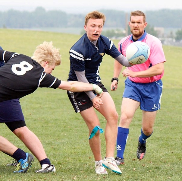 Cochrane Rugby&#8217;s Rylen Waugh passes the ball in Rocky View Sports Association Division tournament play vs. Holy Trinity Academy Knights of Okotoks May 28 in Calgary.