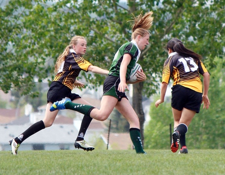 Springbank Community High School Phoenix Marguerite Medwid streaks down the west boundary en route to scoring her second try of the first half in Alberta Schools&#8217;
