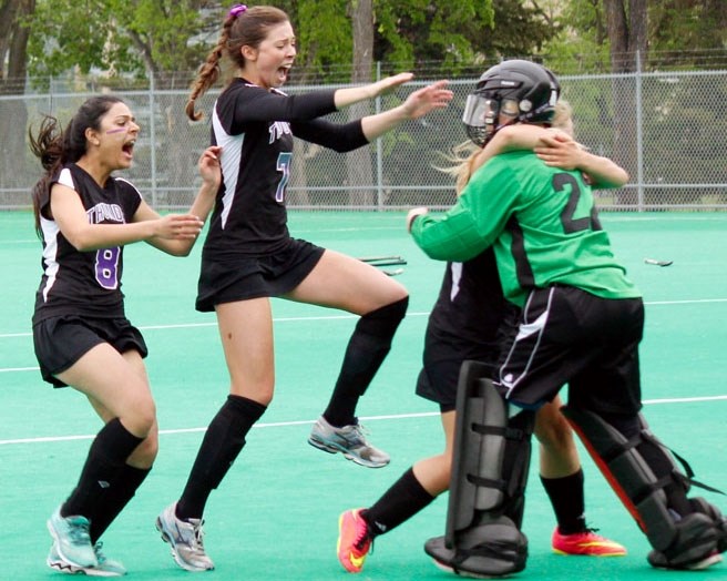 St. Timothy High School Thunder&#8217;s Kavita Atwal (from left) and Seela Wulff mob goalie Emily Wasylyniuk after Thunder won Calgary Senior High School Athletic Association 