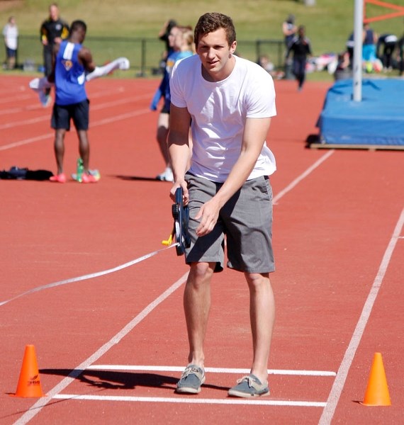 Bow Valley High School Class of &#8217;14 grad Cole Lethebe supervises the long-jump pit at Rocky View Sports Associaiton high school Divisional track championships last