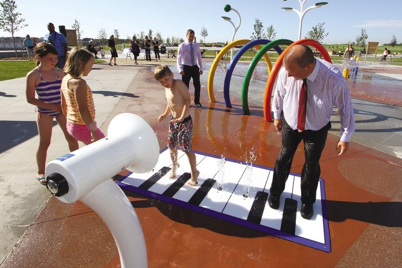 Airdrie mayor Peter Brown runs through one of the new toys at the Mattamy Homes Airdrie Splash Park during its grand opening. The park has been open for a few years, and with 