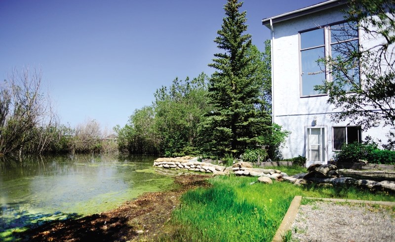 The backyard of a Cochrane Lake-area home floods last summer.