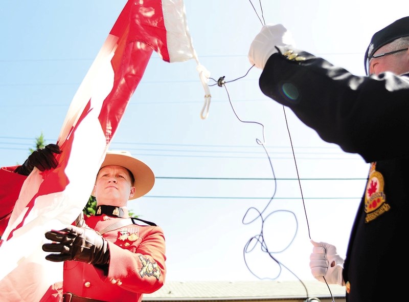 The Canadian flag is raised for Canada Day at the Cochrane Royal Canadian Legion.
