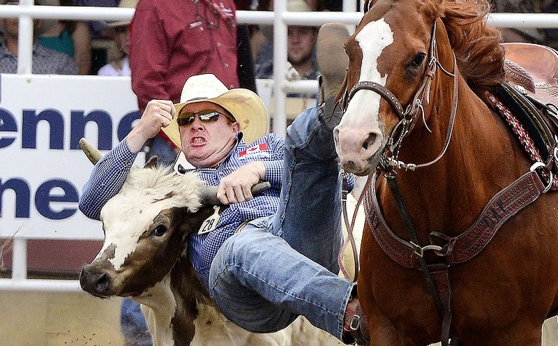 Cochrane&#8217;s Tanner Milan goes to work in Calgary Stampede Pool A steer-wrestling action July 4. Aboard his new horse, Smoke, Milan threw down a 4.2-second time, tying