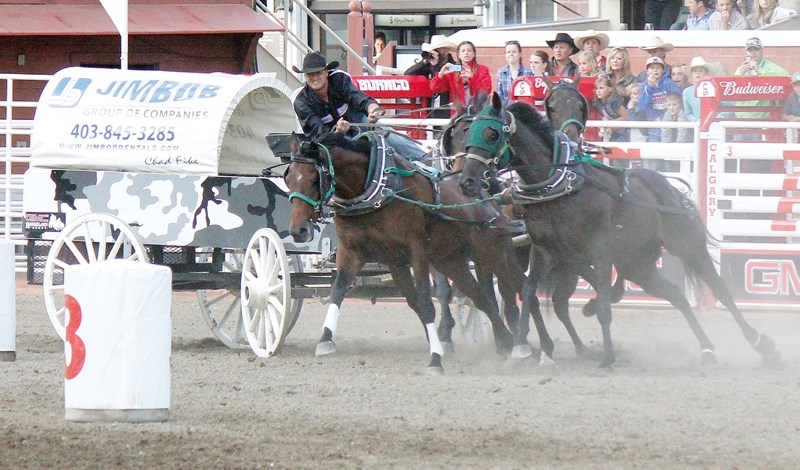 Cremona&#8217;s Chad Fike works his team off the 3 barrel at Calgary Stampede&#8217;s GMC Rangeland Derby on July 5. He admits there is a certain level of risk in wagon
