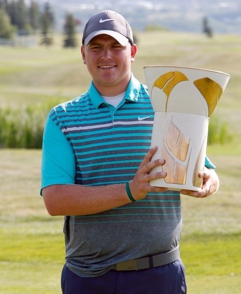 California golfer Daniel Miernicki clutches the trophy Aug. 2 for winning the ATB Financial Classic golf tournament at The Links of GlenEagles in Cochrane.
