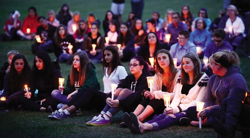 Many Cochrane youth came out to Mitford Park Aug. 14 to hold a candlelight vigil to remember three local 18 year olds who lost their lives during the past two months.