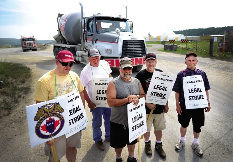 Crews from the Cochrane Burnco site strike in front of a cement truck, slowing the companies ability to deliver product.