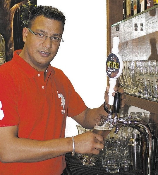 Owner of Mehtab East Indian Cuisine Jag Thind pours a pint of his restaurant&#8217;s new beverage offering, Mehtab Lager. The beer, which is brewed in Calgary at Minhas Micro 