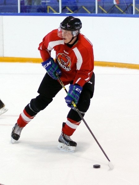 Cochrane Minor Hockey product Coda Gordon prepares to fire a pass into the slot during University of Calgary Dinos hockey practice Sept. 3 at the Olympic Oval on U of C