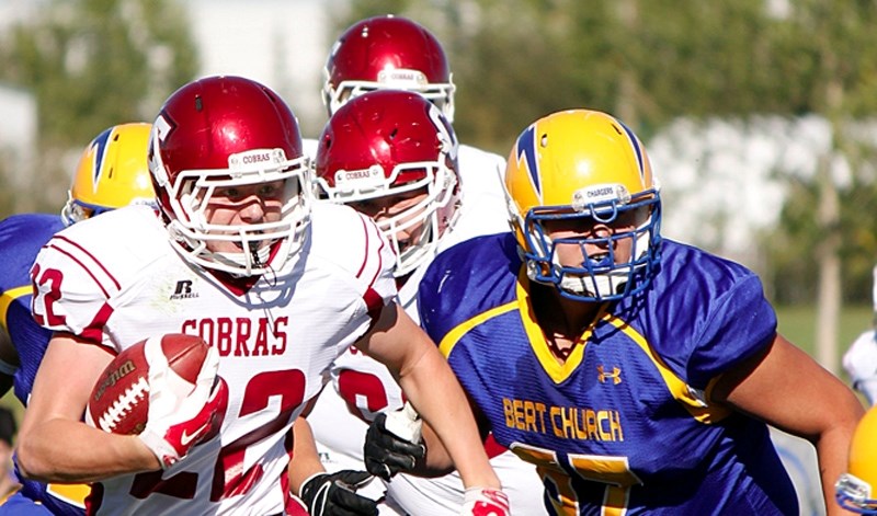 Cochrane Cobras running back Cole Avery gallops through Bert Church Chargers defence in Rocky View Sports Association football season-opening play Sept. 11 at Airdrie. Cobras 
