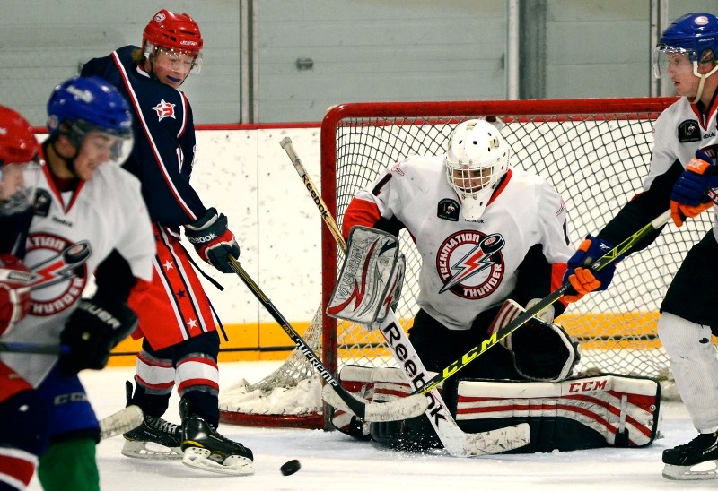 Cochrane Generals Talus Hume tips a shot on Airdrie Thunder goalie Lanny Blitt in Heritage Junior Hockey League Exhibition Showdown play Sept 18 in Cochrane. Gens won 4-2.