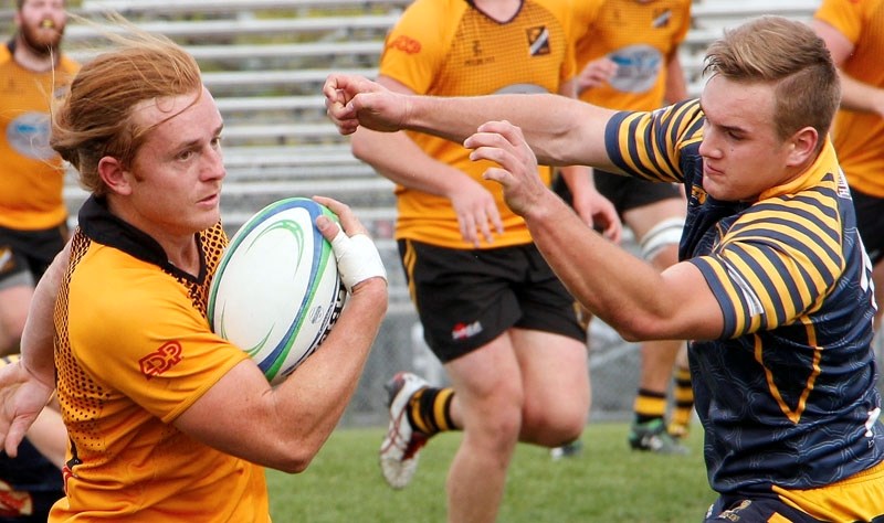 Bow Valley Grizzlies&#8217; James Patterson (right) moves in for a tackle in Calgary Rugby Union Second Division men&#8217;s playoff play at Calgary Hornets on Sept. 19.
