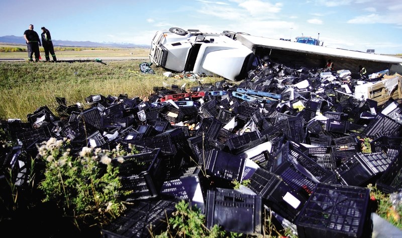 A tractor-trailer flipped over on the Hwy 22 exit from the Trans-Canada Sept. 29, spilling a load of B.C. fruits and vegetables.