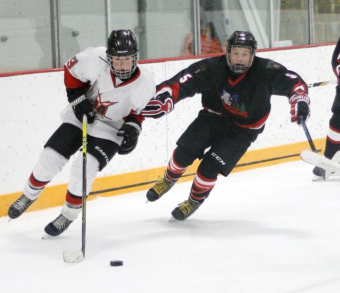 Bow Valley Timberwolves defenceman Dean Olenyk chases Airdrie Lightning puck-carrier Brennen Wingenbach in South Central Alberta Bantam AA Hockey League play Sept. 25 in