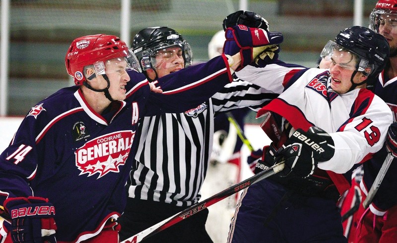 Cochrane Generals defenceman Logan Brown sends a message to visiting Okotoks Bisons&#8217; Matthew Pronchuk in Heritage Junior Hockey League play Oct. 3 at Cochrane&#8217;s