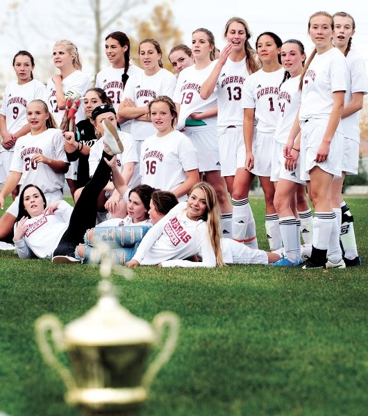 Cochrane High School Cobras celebrate their Rocky View Sports Association varsity girl&#8217;s Division soccer title Oct. 8 in Airdrie.