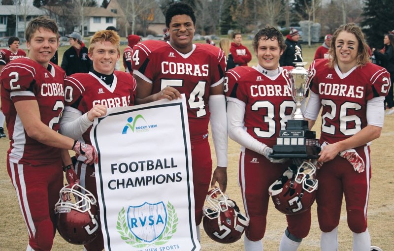 Cobras players (left to right) Ethan Forrest,Tae Gordon, Justin Sambu, Austin Yersel, and Erik Nusl proudly display the RVSA Division banner and trophy after defeating George 