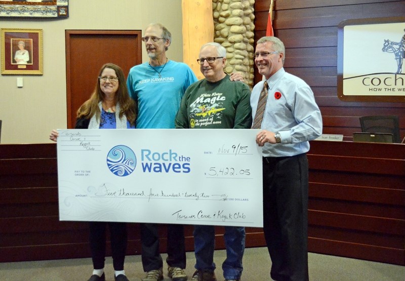 The Tarsands Canoe and Kayak club presents a cheque at the Nov. 9 Cochrane town council meeting, donating $5,422.05 to the Rock the Waves foundation. (From left): Tarsands