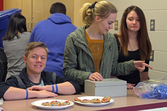 Cochrane High School Grade 12 students (from left) Geoffrey McMorland, Claire Forbes, and Erica Mackintosh, members of the school&#8217;s Psychology Club, use their lunch