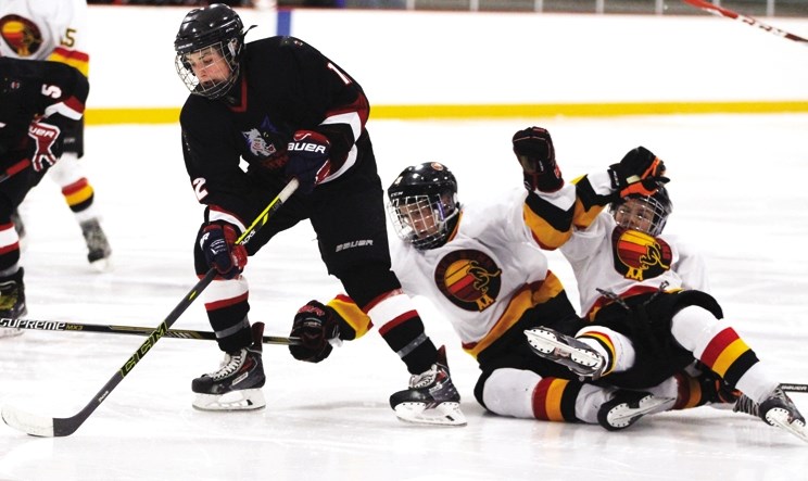 Bow Valley Timberwolves&#8217; Morgan Wulff leaves a pair of Taber Golden Suns players in his wake during South Central Alberta Bantam AA Hockey League play Nov. 21 in
