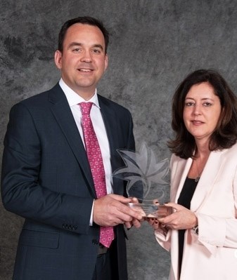 Conservative Banff-Airdrie MP Blake Richards receives the Tourism Champion Award on Dec. 2 from Tourism Association of Canada president and CEO Charlotte Bell.
