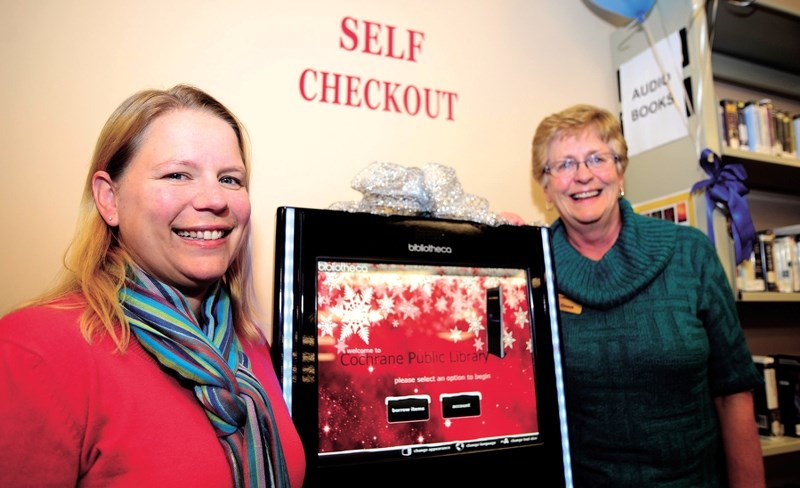 For photos ID TOC Library board chair Joan Urschel. Andrea Beck (in red), chair, Friends of Nan Boothby Memorial Library (fundraising arm)