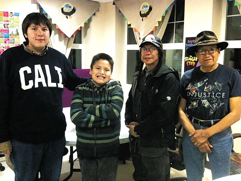 Roland Rollinmud (right) and recipients of community program grant for Stoney Nakoda First Nation children and families.