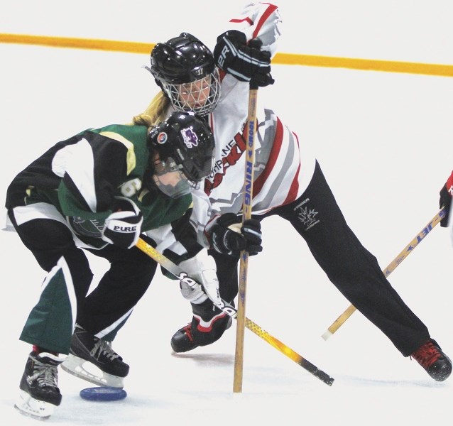 Cochrane Rockies&#8217; Grace E. Johnson (right) battles a Spruce Grove Renegades player during her team&#8217;s 5-1 loss in the Under-14A final on Dec. 13.