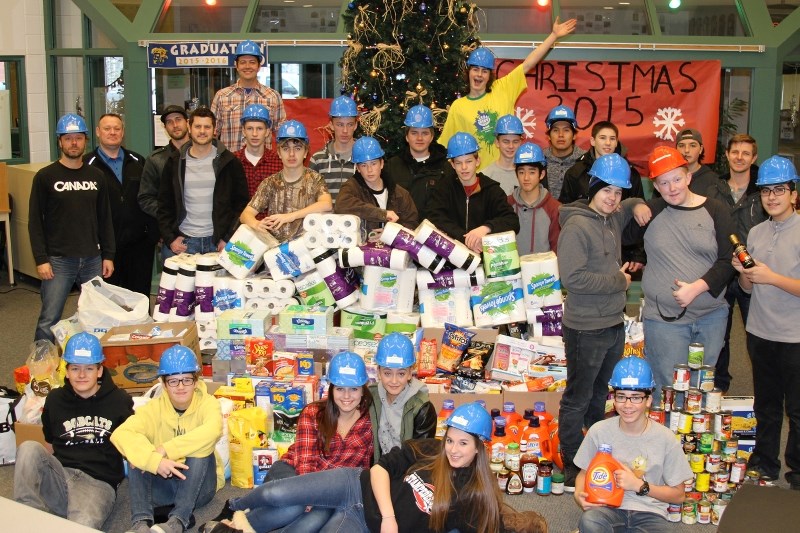 The adults without hats, pictured with Bow Valley High School students, are representatives of some of this year&#8217;s Bow Valley High School Helping Hampers sponsors.