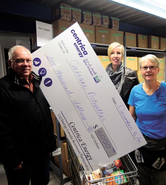 John Green (from left), operations superintendent for Centrica Energy and Kaili Dale, Centrica&#8217;s payroll and community investment coordinator, donate $6,000 to Ann