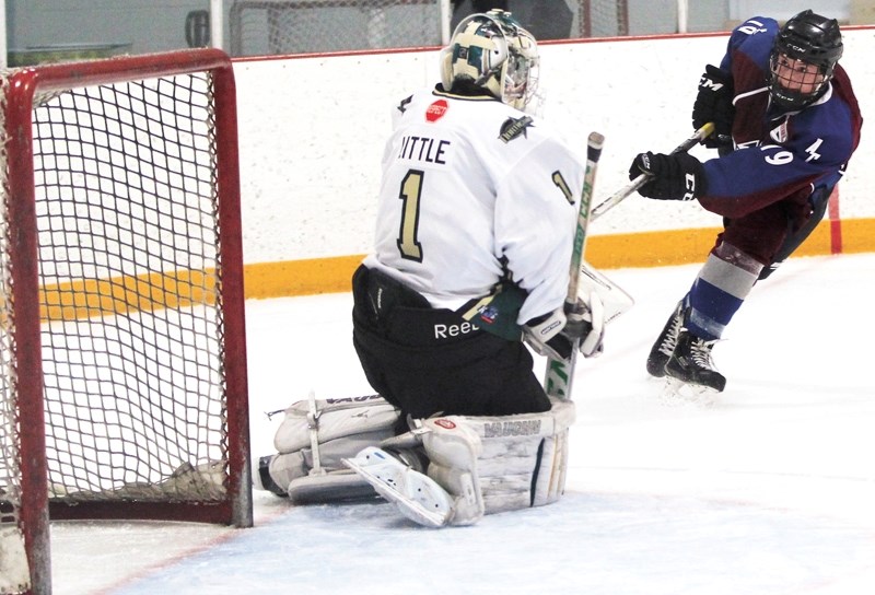 AC Avalanche forward Cole Reinhardt has his shot stopped by CNHA Blazers netminder Jackson Little during Avs&#8217; 5-4 win on Jan. 2.
