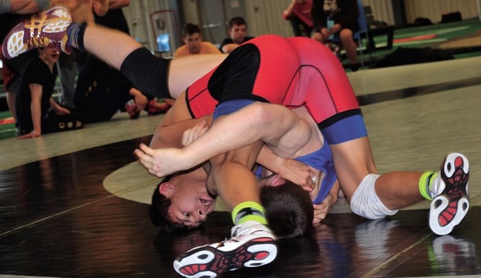 Cochrane Cowboys wrestler Charles Cook tries to get the upper-hand during a match in Grand Prairie over the weekend of Jan. 15-16. The Senior High wrestler ended up taking