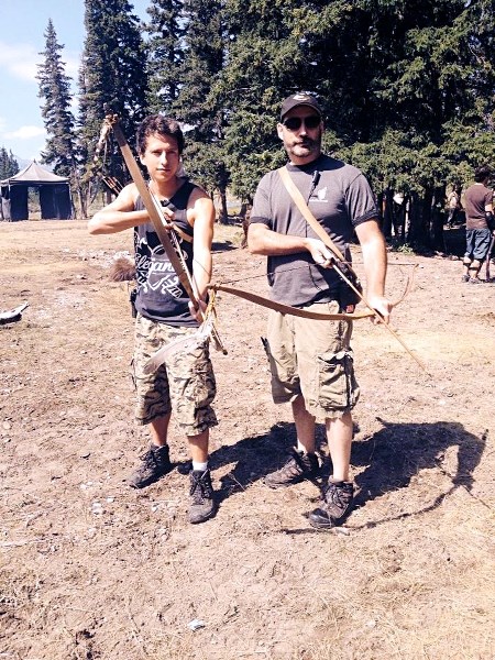 Cochranite Chris Ball with assistant prop master Jason Landels, posing with arrows on set of the Oscar-nominated film, The Revenant, shot in Kananaskis Country where Ball