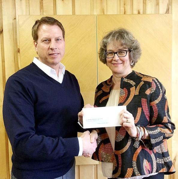 Pat Findlater, chief financial officer from Spray Lake Sawmills, presents Laurel Pedersen, executive director of the Cochrane Pregnancy Care Centre, with a cheque Feb. 10.